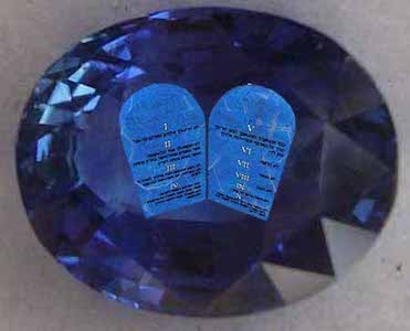 The ten commandments written on tablets of unpolished sapphire sitting inside a polished sapphire gem